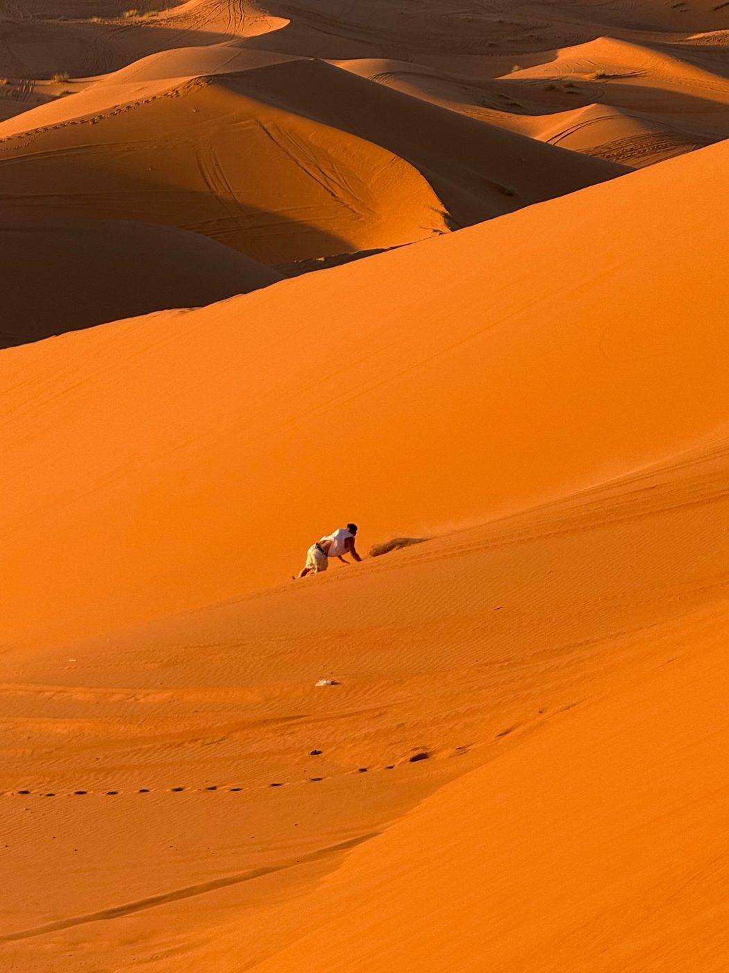 Running down a dune at sunset