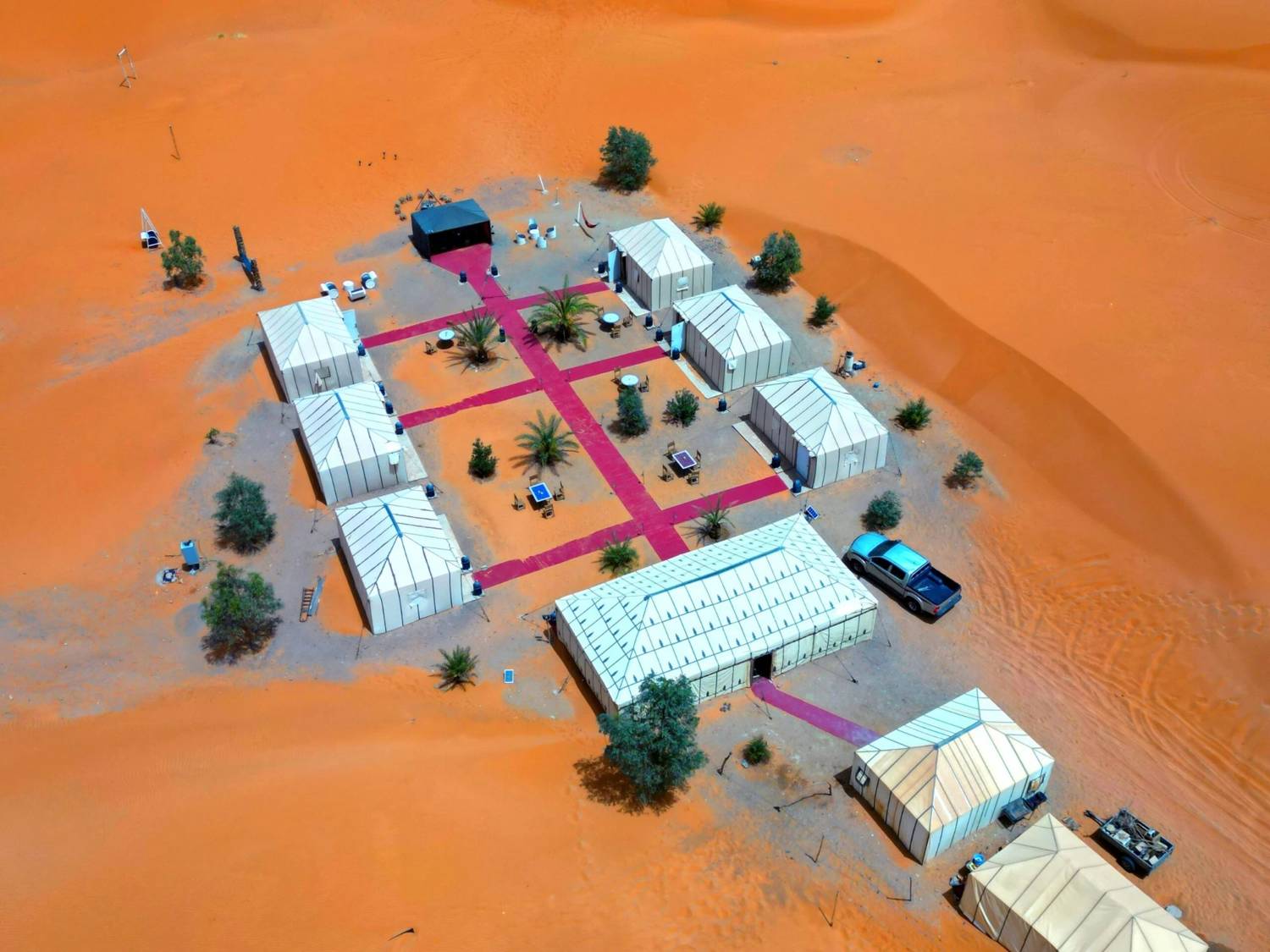 Aerial view of Camel Trips Luxury Camp: tents and restaurant among the dunes of Merzouga